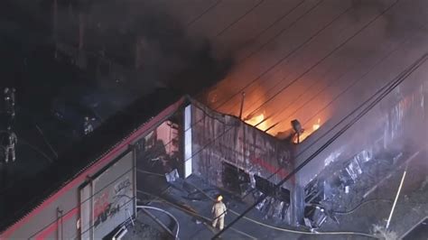 Fire involving multiple vehicles erupts in Pacoima auto yard